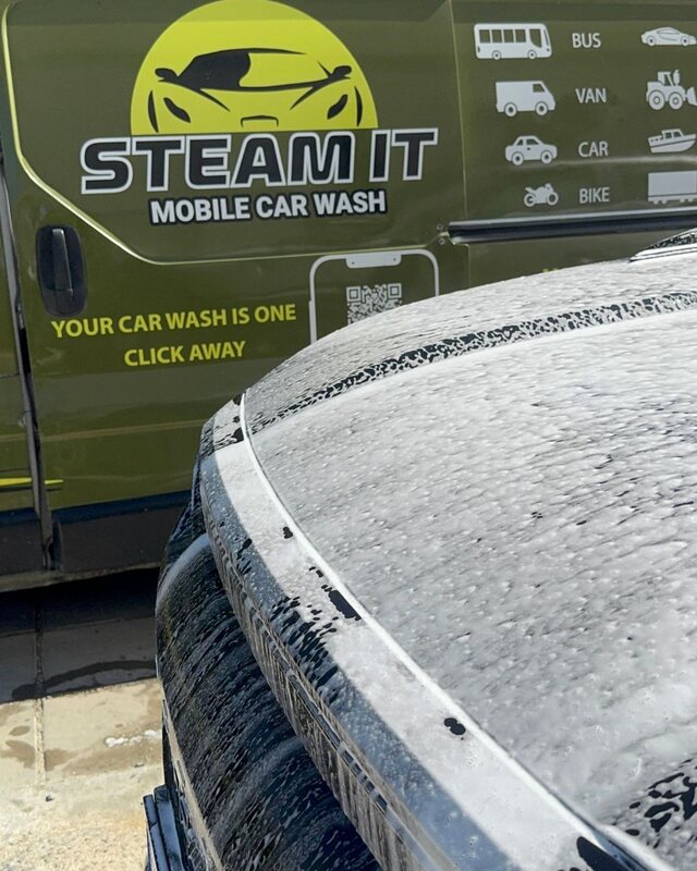 Foam on a car with the Steamit service vehicle behind
